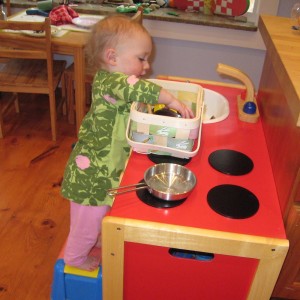 red wooden play kitchen